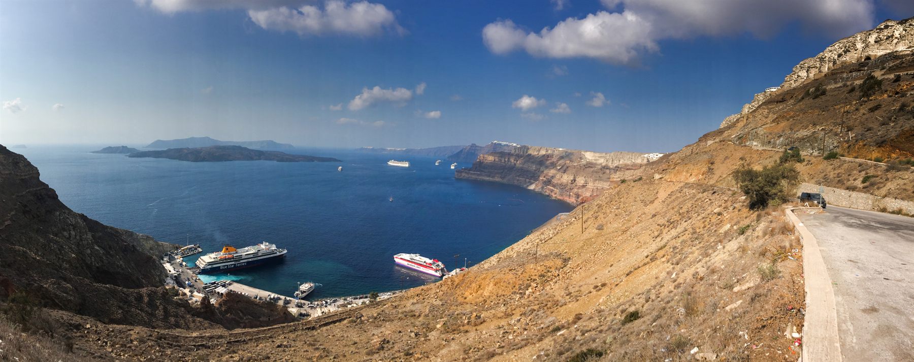 A modern luxury cruise ship anchored off Santorini in the Greek Isles